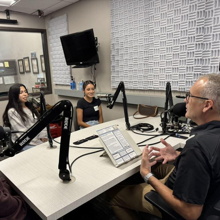  Matthew Ray speaks with college students while recording the podcast